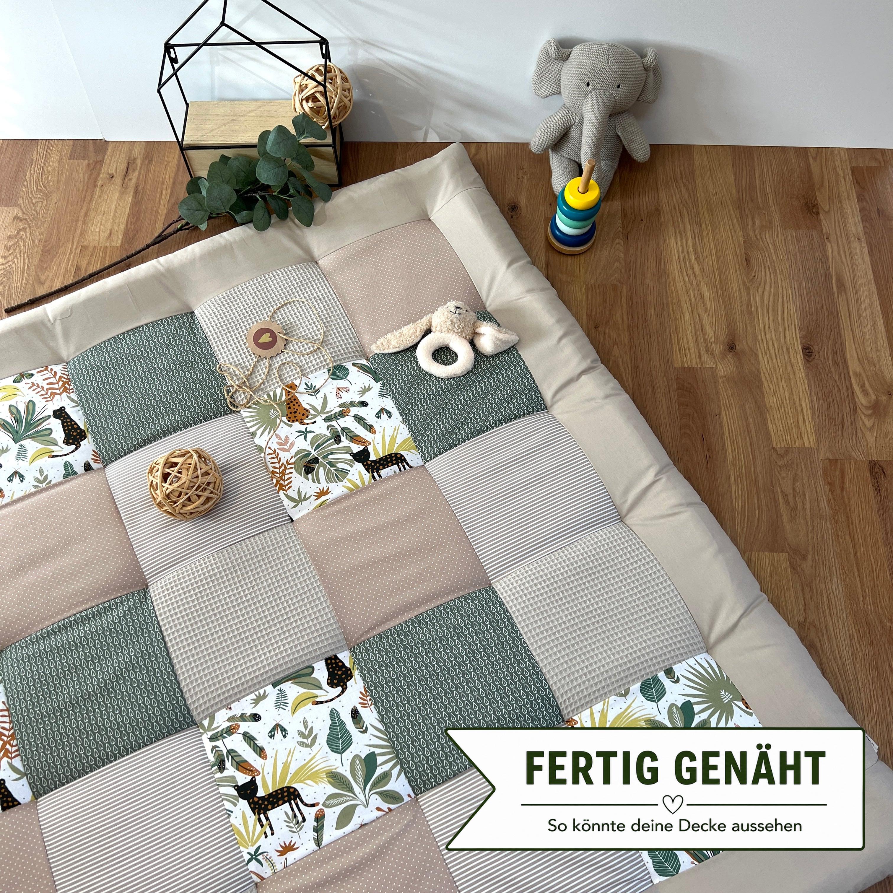 a patchwork quilt with a variety of colorful squares, a stuffed elephant toy, and some decorative elements such as a potted plant and a woven basket.