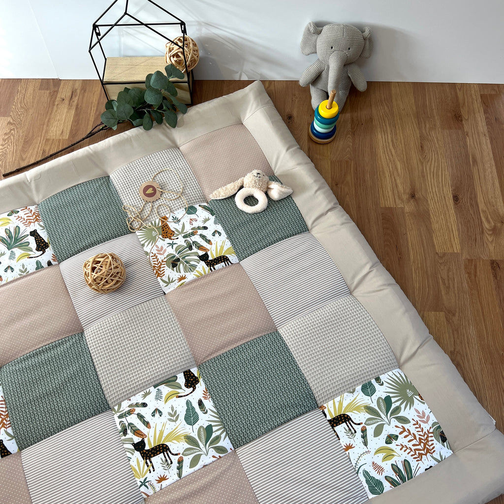 a patchwork quilt with a variety of colorful squares, a stuffed elephant toy, and some decorative elements such as a potted plant and a woven basket.