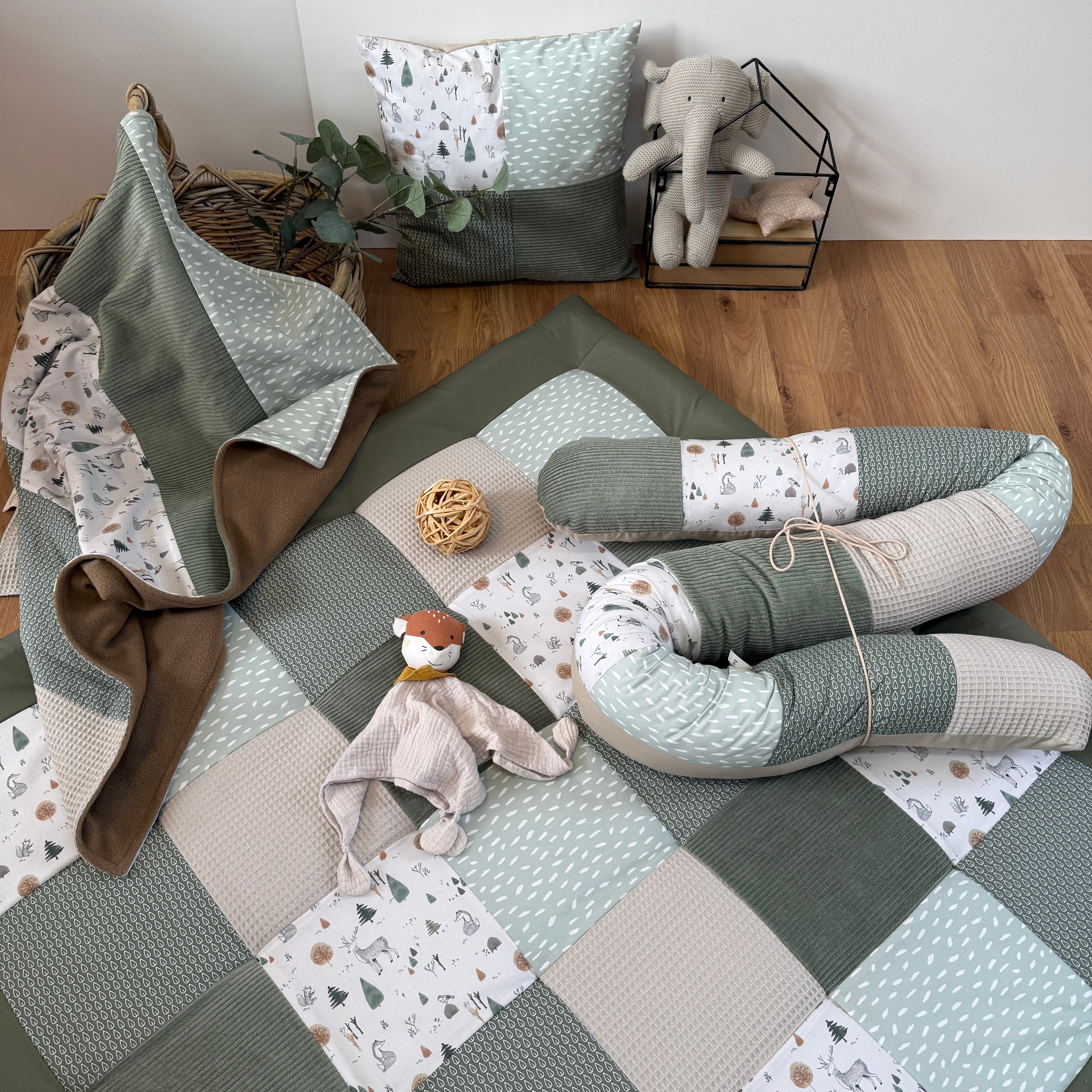 a cozy and inviting nursery setting with a quilt, stuffed animals, and a basket.
